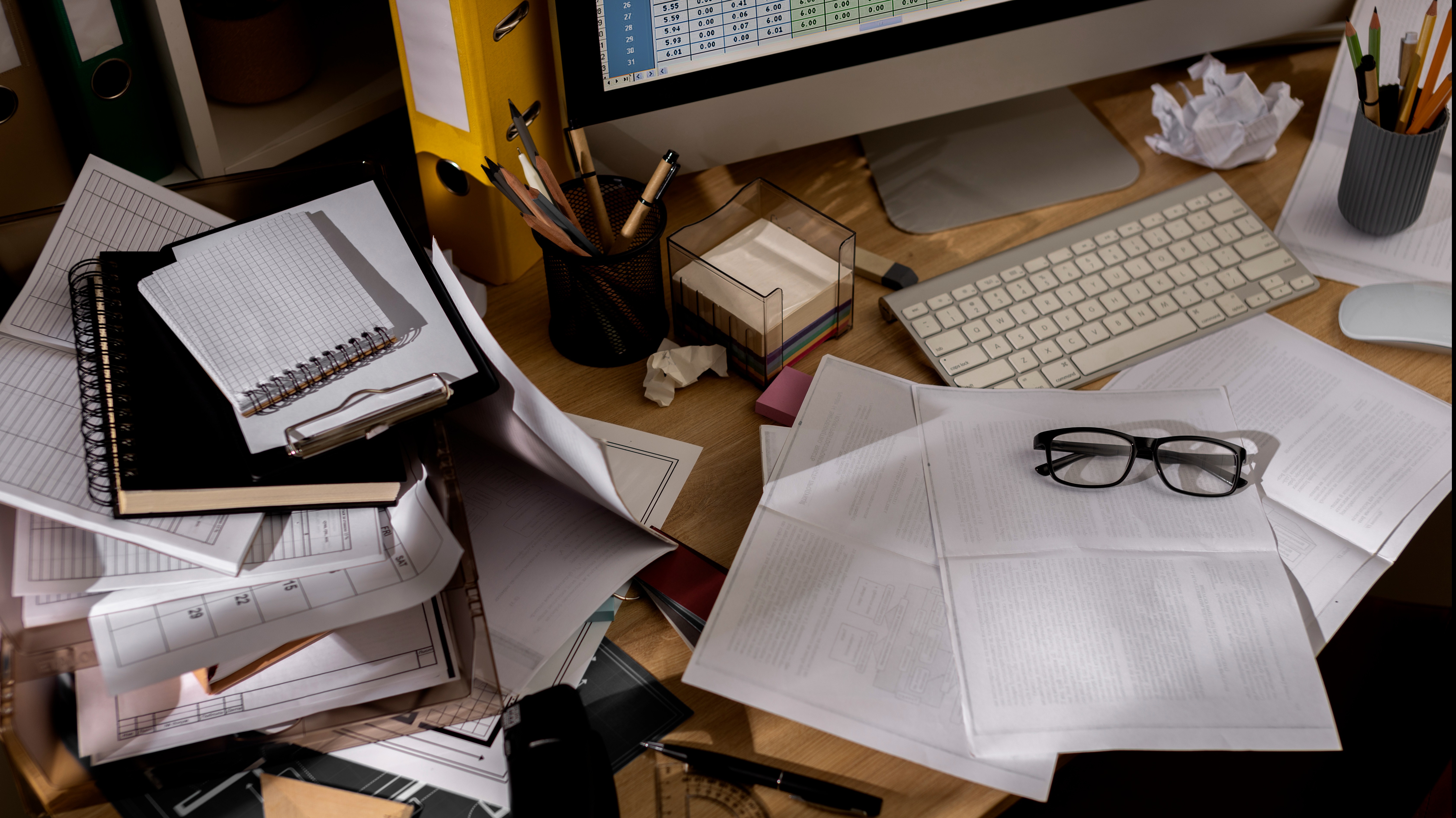 A self-employed person working on a laptop at a modern home office desk.